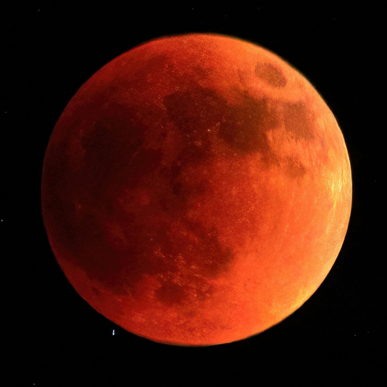 A striking image of a reddish blood moon during a total lunar eclipse.